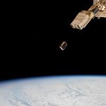 A CubeSat small satellite is ejected into Earth orbit from a deployer outside the International Space Station