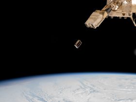 A CubeSat small satellite is ejected into Earth orbit from a deployer outside the International Space Station